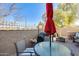 Outdoor patio with a glass top table set, grill, wrought iron fencing, and privacy walls at 2868 E Dunbar Dr, Phoenix, AZ 85042