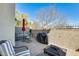 Outdoor patio with a dining table set, covered grill, privacy wall, and wrought iron fence at 2868 E Dunbar Dr, Phoenix, AZ 85042