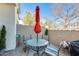 Cozy patio with a round dining table set, privacy walls, and lush landscaping at 2868 E Dunbar Dr, Phoenix, AZ 85042