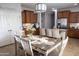 Inviting kitchen and dining room featuring wood cabinets, an island, and a decorative chandelier at 29902 N 71St Ave, Peoria, AZ 85383