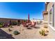 Expansive desert landscaped backyard features a brick paver patio and seating area at 29986 N Jillian Dr, San Tan Valley, AZ 85143