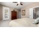 Bedroom featuring wood furniture, an open door leading to ensuite bathroom, and backyard access at 29986 N Jillian Dr, San Tan Valley, AZ 85143