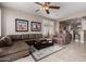 Living room features tile flooring, neutral-colored walls, sectional sofa and view into the kitchen at 29986 N Jillian Dr, San Tan Valley, AZ 85143