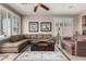 Inviting living room with a sectional sofa, decorative rug, and a ceiling fan for a comfortable ambiance at 29986 N Jillian Dr, San Tan Valley, AZ 85143