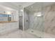 Luxurious bathroom with marble floors, a glass-enclosed shower, and granite countertops at 302 W Stella Ln, Phoenix, AZ 85013