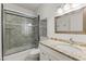 Bathroom with granite counter tops, white cabinets and enclosed shower and tub at 302 W Stella Ln, Phoenix, AZ 85013