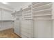 Walk-in closet with white shelving and drawers, providing ample storage space and organization at 302 W Stella Ln, Phoenix, AZ 85013