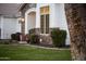 Lush landscaping around the home's exterior with stone accents and a well-manicured lawn at 302 W Stella Ln, Phoenix, AZ 85013