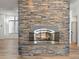 Stone fireplace with hearth and an open concept layout, and hardwood floors at 302 W Stella Ln, Phoenix, AZ 85013