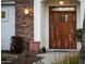 Inviting front door features decorative glass, stone accents, and exterior lighting at 302 W Stella Ln, Phoenix, AZ 85013