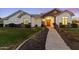 Charming home exterior with a stone accent wall, manicured lawn, and welcoming front entrance at 302 W Stella Ln, Phoenix, AZ 85013