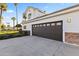 Three car garage with a traditional paneled door and stone detailing matching the house at 302 W Stella Ln, Phoenix, AZ 85013