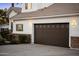 Spacious three car garage with a traditional paneled door and stone detailing matching the house at 302 W Stella Ln, Phoenix, AZ 85013