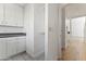 Bright hallway featuring white cabinets and shelving with tile flooring leading to the main living area at 302 W Stella Ln, Phoenix, AZ 85013