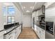 Modern kitchen with stainless steel appliances, black countertops, and ample natural light at 302 W Stella Ln, Phoenix, AZ 85013