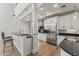 Bright kitchen features white cabinetry, stainless steel appliances, hardwood floors, and a sleek black countertop bar at 302 W Stella Ln, Phoenix, AZ 85013