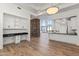 Bright living room with modern built-ins, and a kitchen with modern appliances at 302 W Stella Ln, Phoenix, AZ 85013