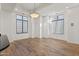 Spacious living room featuring hardwood floors, recessed lighting, and bright windows with custom blinds at 302 W Stella Ln, Phoenix, AZ 85013