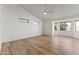 Bright main bedroom featuring hardwood floors, a ceiling fan, and bright windows at 302 W Stella Ln, Phoenix, AZ 85013