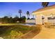 Outdoor pool with a covered patio, lush greenery, and a grass yard at 302 W Stella Ln, Phoenix, AZ 85013