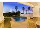 Backyard pool with an outdoor covered patio and lush greenery at 302 W Stella Ln, Phoenix, AZ 85013