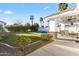 Backyard pool with an outdoor covered patio and lush greenery with palm trees at 302 W Stella Ln, Phoenix, AZ 85013