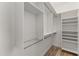 Walk-in closet with custom shelves, hanging rods, and a sleek, modern design at 302 W Stella Ln, Phoenix, AZ 85013