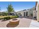 Backyard featuring a brick patio with built-in fire pit and lush landscaping at 32 E 14Th St, Tempe, AZ 85281