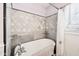 Elegant bathtub with tile surround, shower curtain, and bright window at 32 E 14Th St, Tempe, AZ 85281