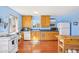 Bright kitchen with white appliances, hardwood floors, and light blue walls at 32 E 14Th St, Tempe, AZ 85281