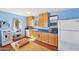 Bright kitchen with white appliances, hardwood floors, and light blue walls at 32 E 14Th St, Tempe, AZ 85281