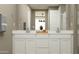 Elegant bathroom featuring double sinks, white cabinetry, and neutral color scheme at 3223 E Baler Dr, San Tan Valley, AZ 85140