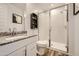 Well-lit bathroom featuring white cabinets, granite countertops, and a glass door shower at 3314 E Ranchhand Dr, San Tan Valley, AZ 85140