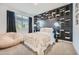 Stylish bedroom with black accent wall and decorative shelf, carpeted flooring, and a window with dark curtains at 3314 E Ranchhand Dr, San Tan Valley, AZ 85140