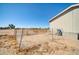 Fenced backyard features desert landscaping and access to the back of the home at 38203 W Willetta St, Tonopah, AZ 85354