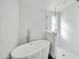 Sleek bathroom featuring a soaking tub and glass-enclosed shower at 38203 W Willetta St, Tonopah, AZ 85354