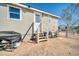 Home exterior featuring a side entrance with stairs, desert landscaping, and backyard access at 38203 W Willetta St, Tonopah, AZ 85354