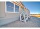 Home exterior featuring stairs to the front entrance and desert landscaping at 38203 W Willetta St, Tonopah, AZ 85354