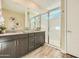 Bathroom with a dual sink vanity, quartz countertop, decorative woven dishes and walk-in shower with glass door at 38233 N Stillmeadow Rd, San Tan Valley, AZ 85140