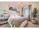 Bedroom with a bed, night stands, a window with curtains, and a decorative tree at 38233 N Stillmeadow Rd, San Tan Valley, AZ 85140