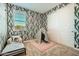 A well-lit ' bedroom with wallpaper with a nature theme, a bed, and a play tent at 38233 N Stillmeadow Rd, San Tan Valley, AZ 85140