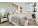 Bedroom with a bed, a bedside table, a plant, decorative mirrors, and a window with blind at 38233 N Stillmeadow Rd, San Tan Valley, AZ 85140