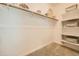 Walk-in closet with a carpeted floor, wood rod, shelving on the right side, and decorative baskets at 38233 N Stillmeadow Rd, San Tan Valley, AZ 85140