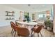 Inviting dining room with a rustic wood table, seating for six, and views into the adjacent living space at 38233 N Stillmeadow Rd, San Tan Valley, AZ 85140