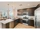 Well-designed kitchen with stainless steel appliances, a large island, and sleek cabinetry for a modern touch at 38233 N Stillmeadow Rd, San Tan Valley, AZ 85140