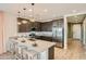 Modern kitchen featuring a quartz countertop island, stainless steel appliances, and ample cabinet space at 38233 N Stillmeadow Rd, San Tan Valley, AZ 85140