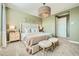 Relaxing main bedroom featuring carpet flooring, a decorative light fixture, and serene decor at 38233 N Stillmeadow Rd, San Tan Valley, AZ 85140