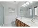 Bright bathroom featuring double sinks, a tiled shower, and a spacious vanity area at 40265 N Acadia Ct, Anthem, AZ 85086