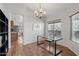 Bright dining room with glass table, laminate floors, and ample natural light at 40265 N Acadia Ct, Anthem, AZ 85086