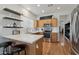 Bright kitchen with modern appliances, white countertops, wood cabinets, subway tile, and floating shelving at 40265 N Acadia Ct, Anthem, AZ 85086